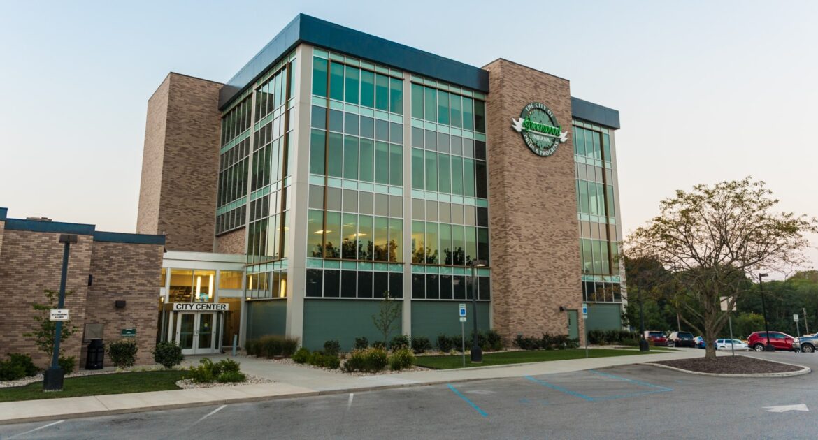 Exterior shot of building in Greenwood, Indiana. The building is four stories tall and comprised of glass walls and brick.