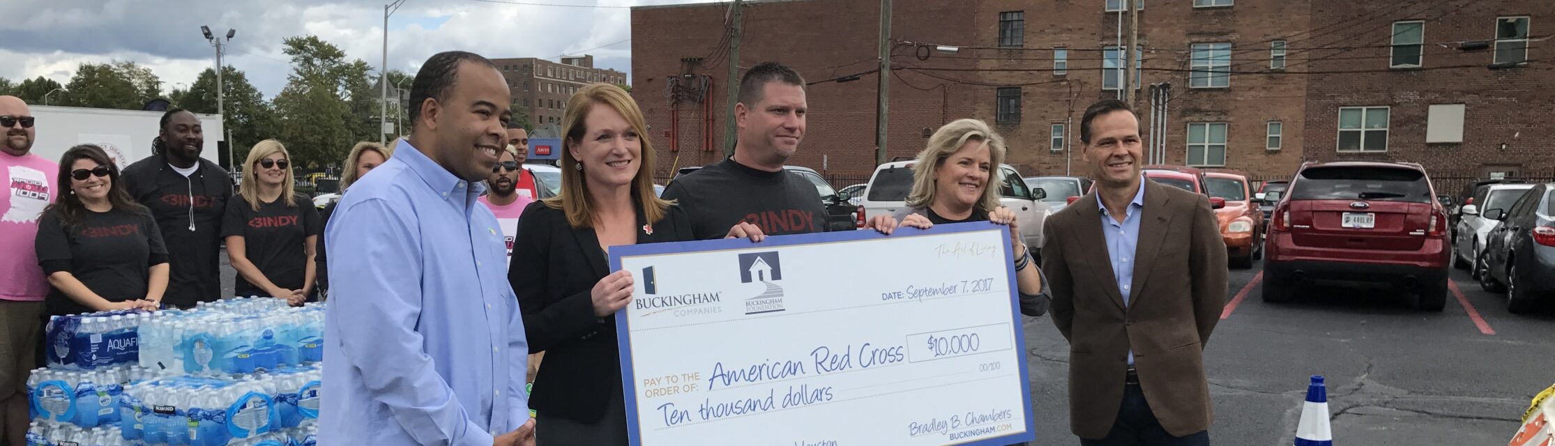 Buckingham Foundation staff holding a check for $10,000 to American Red Cross